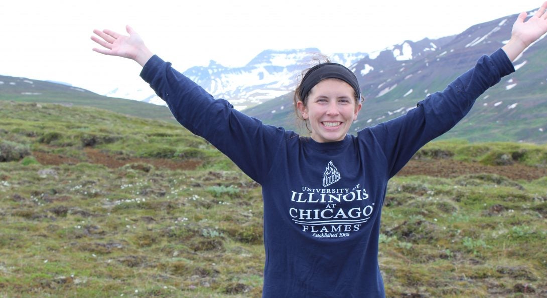 Leigha stands in a field in front of mountains